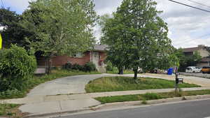 View of property featuring concrete circle driveway for easy access to enter/exit main street