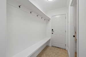 Mudroom featuring crown molding