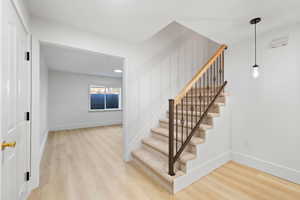 Carpeted staircase opening to basement mother-in-law apartment