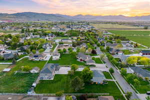 Aerial view at dusk of neighborhood with mountain backdrop