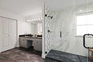 Primary bathroom featuring double vanity with quartz countertops, marbled tile flooring, and a walk-in shower with euro-glass and dual showerheads