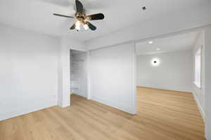 Basement family room featuring recessed lighting, modern wall sconces, and light LVP flooring