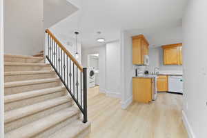 Carpeted staircase opening to basement mother-in-law apartment