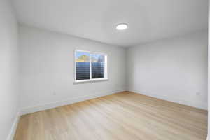 Basement bedroom featuring light LVP flooring