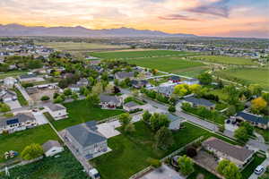 Aerial view at dusk of neighborhood with mountain backdrop