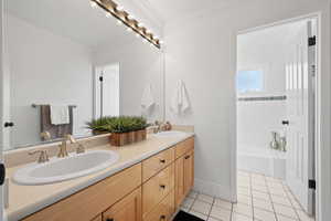 Full bathroom featuring tile floors, double vanity, and crown molding