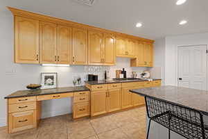 Kitchen with stainless steel appliances, recessed lighting, a large island, quartz countertops and custom backsplash