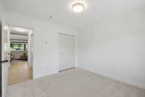 Main floor bedroom or office space with light carpet