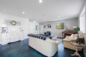ADU living area with finished concrete flooring, recessed lighting, a two-tone paint