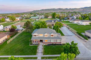 Aerial view at dusk of home and spacious lot with mountain backdrop