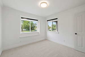 Main floor bedroom or office space with light carpet