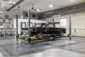 View of finished shop with bar, bathroom, and car lift