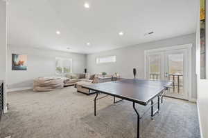 ADU second floor rec room/living room area with French doors leading to a Juliet balcony