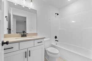 Bathroom with toilet, vanity, and shower / bath combination