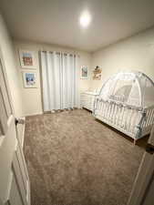 Carpeted bedroom featuring baseboards