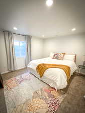 Carpeted bedroom featuring recessed lighting and baseboards