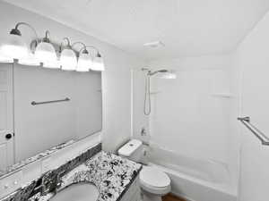 Full bath featuring toilet, shower / bathtub combination, and vanity