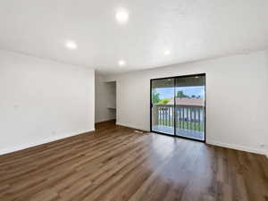 Unfurnished room with baseboards, wood finished floors, and recessed lighting