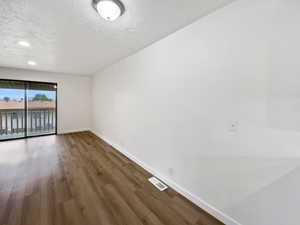 Unfurnished room featuring baseboards and wood finished floors