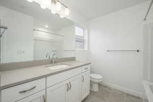 With a combination tub and shower, modern vanity, and thoughtful lighting, this space balances style and function perfectly.