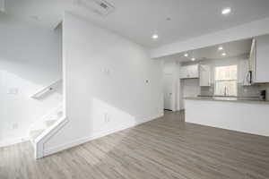 Host game nights or unwind after a long day in this inviting living area filled with natural light.