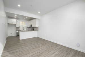 Host game nights or unwind after a long day in this inviting living area filled with natural light.