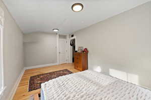 Spacious bedroom with hardwood floors and two-tone paint