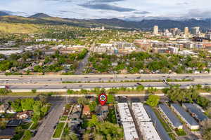 Aerial view of property's location featuring a mountain backdrop and nearby urban area