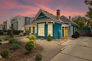 View of front of home featuring covered porch and fence