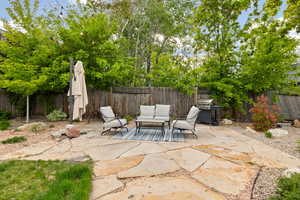 View of patio featuring a grill, a fenced backyard, and outdoor lounge area