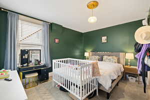 Primary bedroom with carpeted flooring