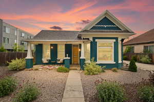 View of front of home featuring covered porch and fence