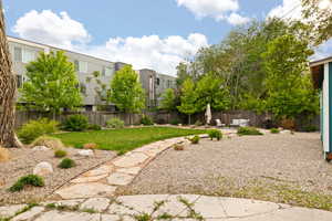 View of secluded yard with professional landscaping, flagstone walkways and patio area