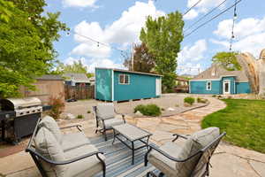 View of patio / terrace with a shop, a storage shed, and outdoor living space