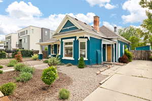 View of front of home with covered porch, and xeriscape front yard