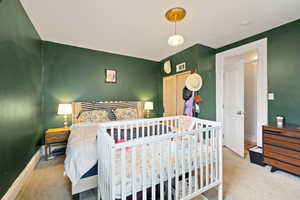 Primary bedroom with carpeted flooring