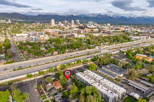 Aerial view of property's location featuring a mountain backdrop and nearby urban area