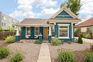 View of front of home with covered porch, and xeriscape front yard