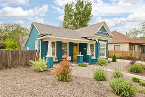 View of front of home with covered porch, and xeriscape front yard