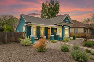 View of front of home with covered porch, and xeriscape front yard
