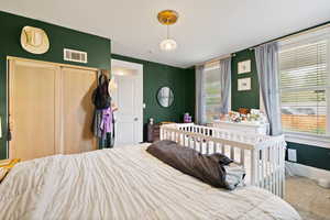 Primary bedroom with carpeted flooring
