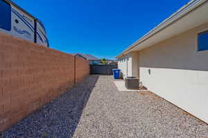 Fenced backyard with central air condition unit