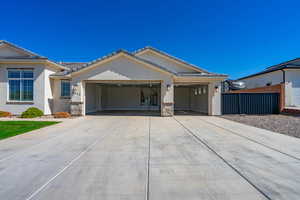 Single story home with an attached garage, concrete driveway, stucco siding, fence, and stone siding