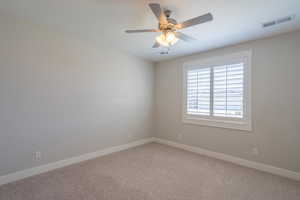 Unfurnished room with baseboards, a ceiling fan, and light carpet
