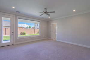 Unfurnished room with crown molding, light colored carpet, a ceiling fan, recessed lighting, and baseboards