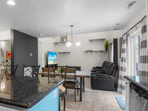 Kitchen featuring a breakfast bar area with granite countertop