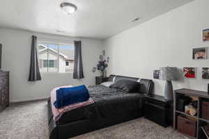 Primary bedroom featuring large window and tons of natural light