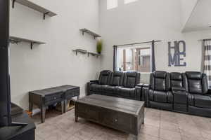 Family room with a high ceilings, lots of natural light and tile floors