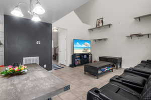 Open family room with tile floors, tall ceilings, and lots of natural light