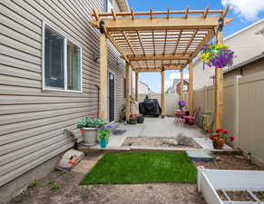 Fenced backyard featuring a patio area, pergola and grass area